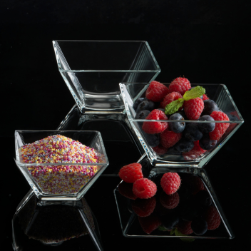 glass bowls filled with berries and sprinkles