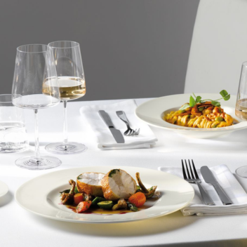 Roast chicken with a glass of wine in a restaurant setting