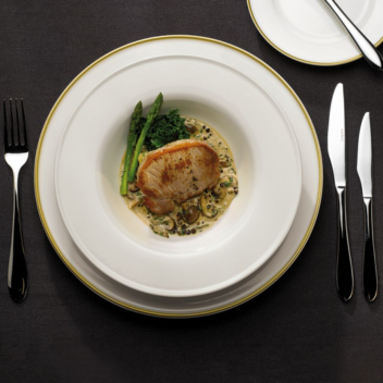 Restaurant meal with pork and greens