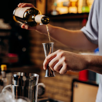 drink being poured into a Jigger